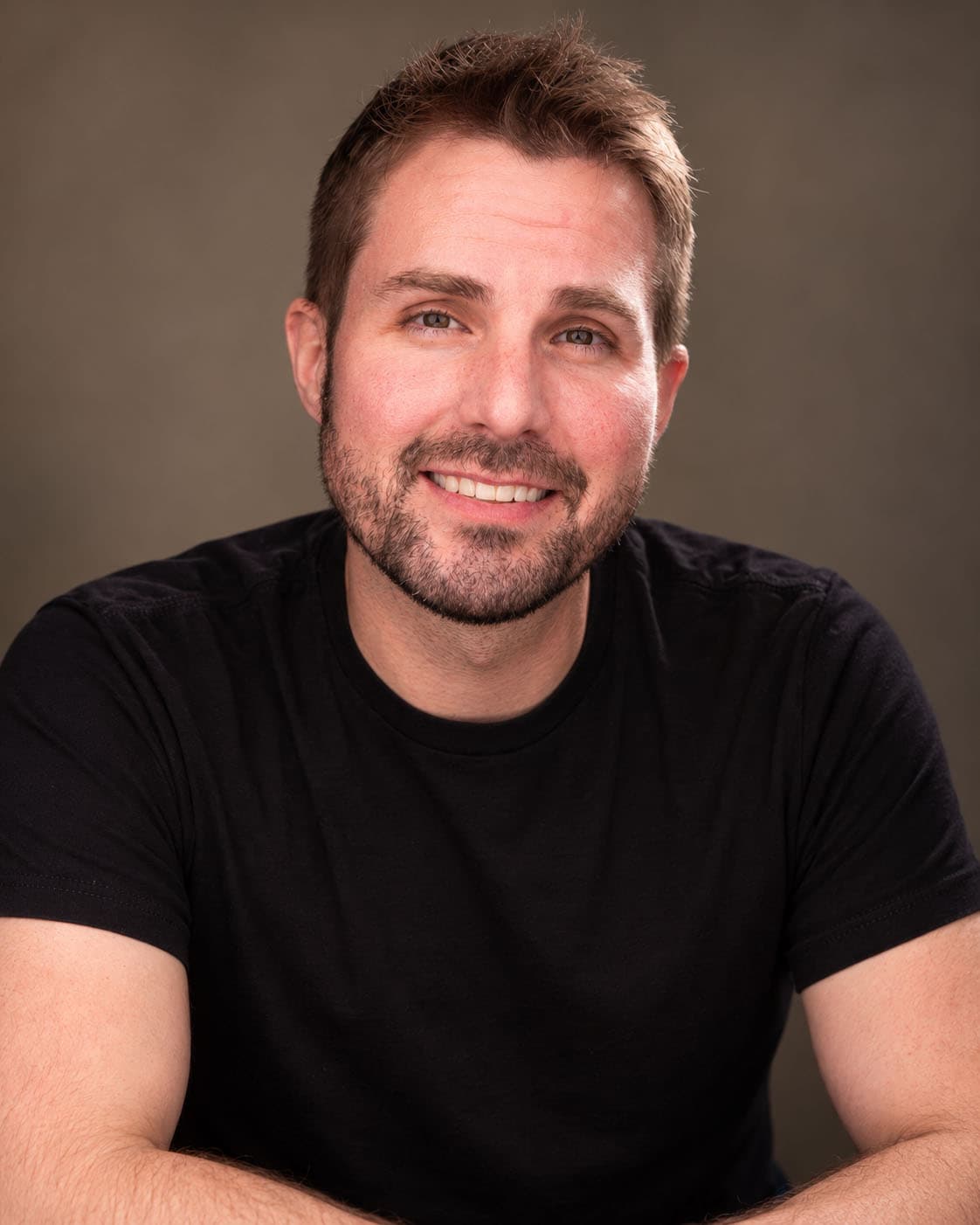 Scott Squire smiling, in a black T-shirt